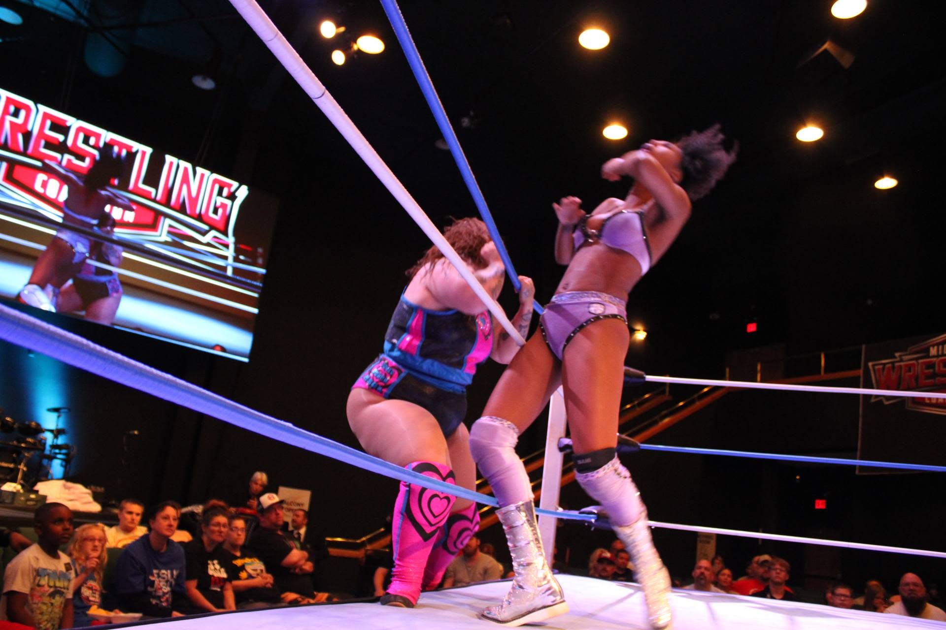 Ashlyn Alexander vs. Alexis Littlefoot — a close exchange near the corner.