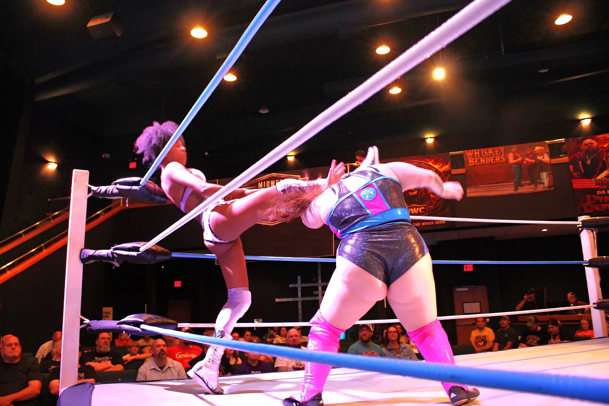 Ashlyn Alexander vs. Alexis Littlefoot — a strike beside the ropes.