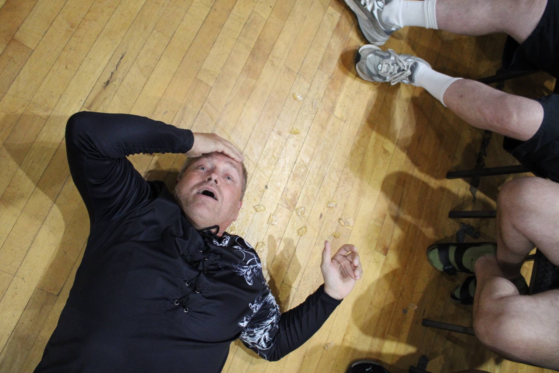 Billy Dutton on the floor after being thrown out of the ring