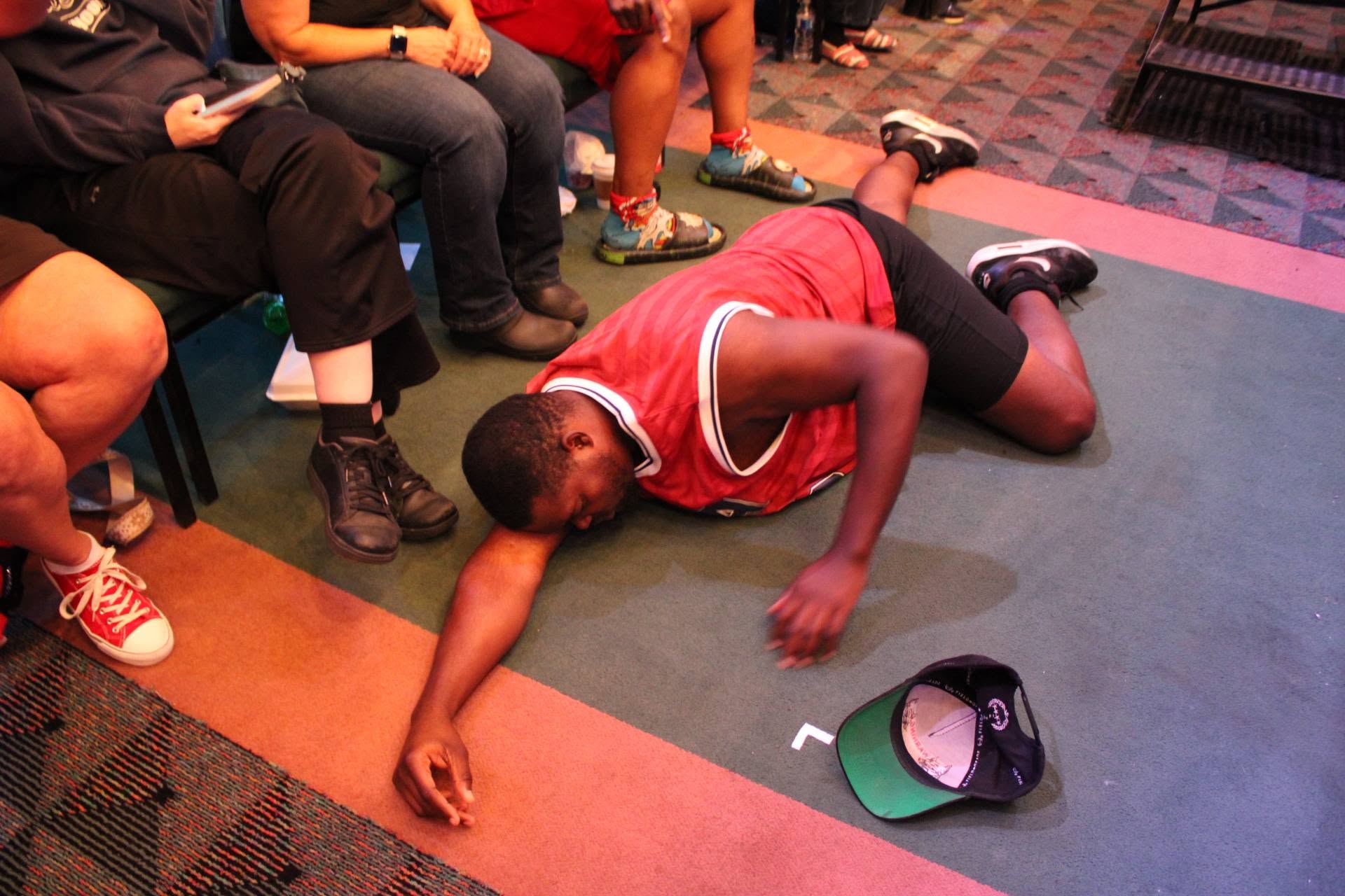 Retro Champion on the ground after being thrown out of the ring