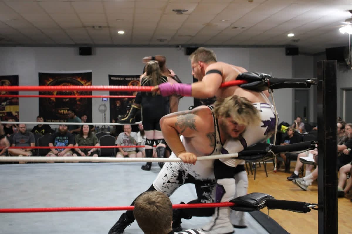 The Apex with purple hand tape in a multi-wrestler match