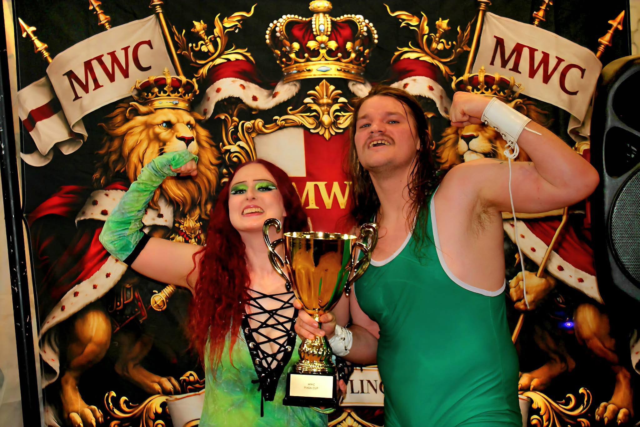 The Platinum Power Couple, Nick Depp and Mercy, holding the Piasa Cup